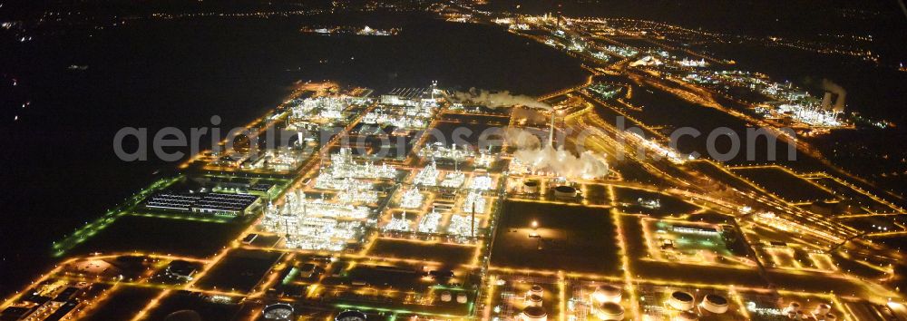 Aerial image at night Leuna - Night lighting tOTAL refinery in central Germany in Leuna in the federal state of Saxony-Anhalt. The TOTAL refinery chemical site Leuna is one of the most modern refineries in Europe