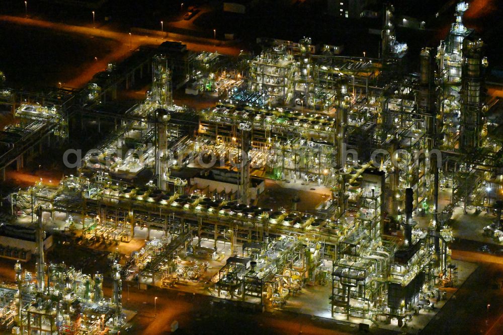 Aerial photograph at night Leuna - Night lighting tOTAL refinery in central Germany in Leuna in the federal state of Saxony-Anhalt. The TOTAL refinery chemical site Leuna is one of the most modern refineries in Europe