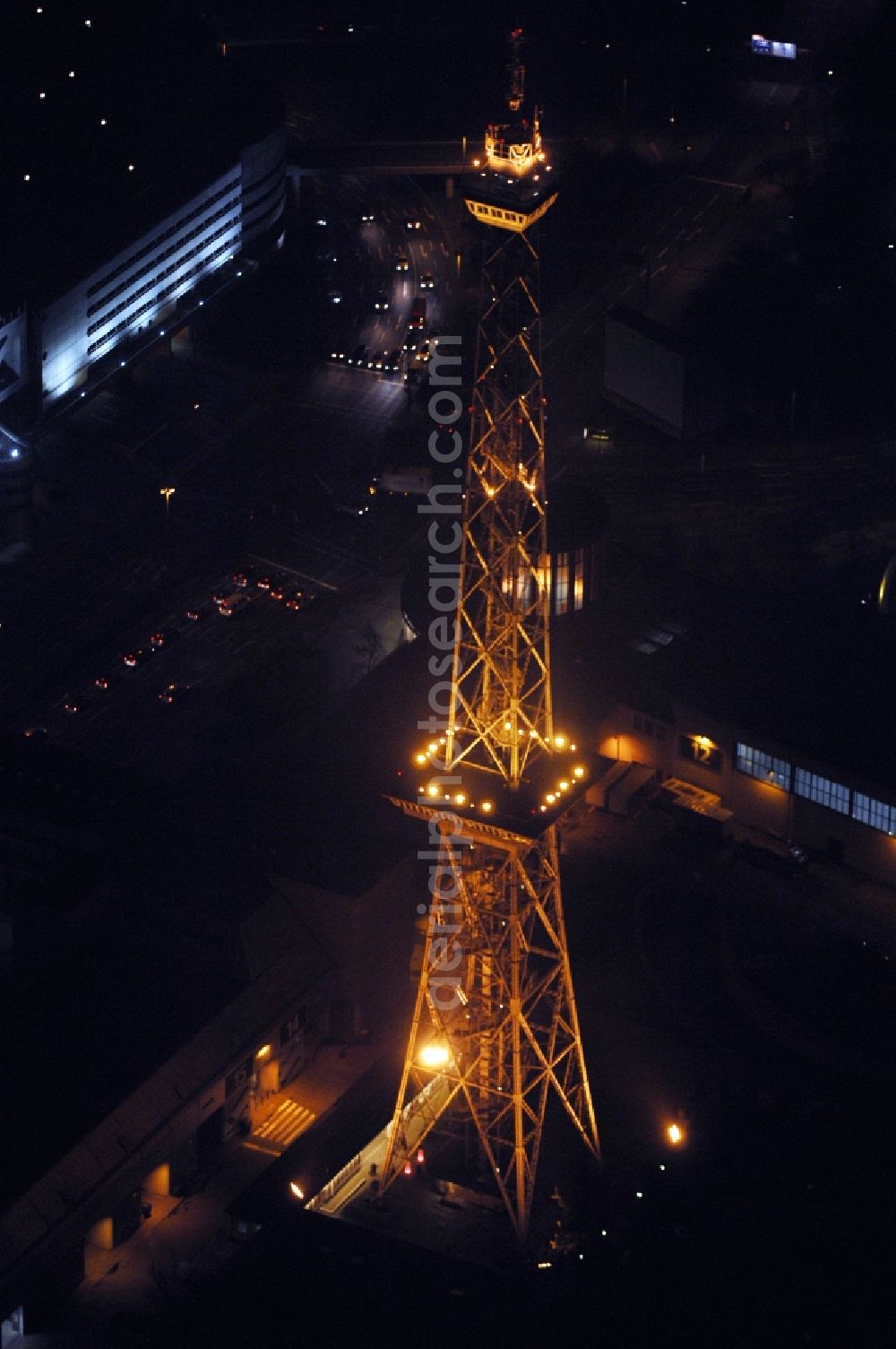 Aerial image at night Berlin - Night lighting Tourist attraction and sightseeing Funkturm on Messegelaende in the district Charlottenburg in Berlin, Germany