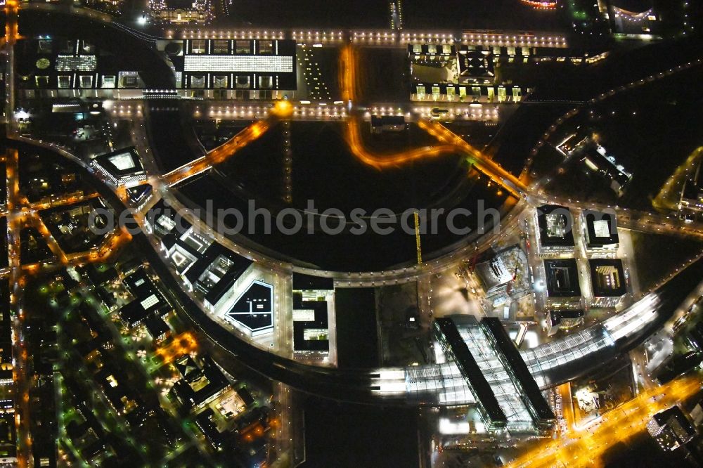 Aerial photograph at night Berlin - Night lighting Riparian zones on the course of the river of Spree on Central Station in the district Mitte in Berlin, Germany
