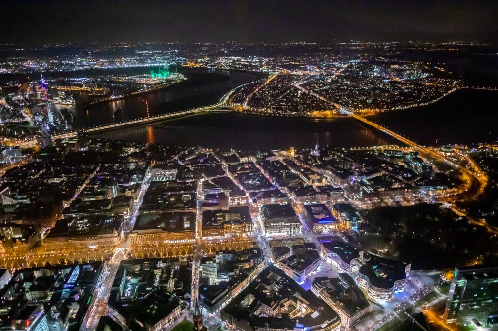 Düsseldorf at night from the bird perspective: Night lighting curved loop of the riparian zones on the course of the river Rhine overlooking the route of the well-known promenade and shopping street Koenigsallee in the district Stadtmitte in Duesseldorf in the state North Rhine-Westphalia, Germany