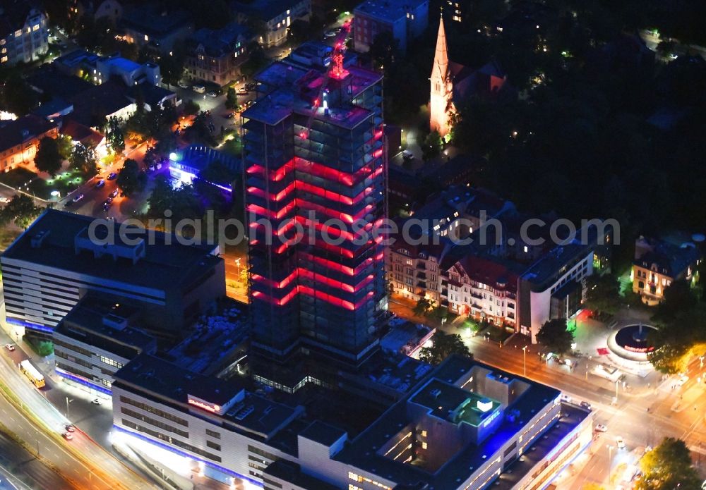 Aerial image at night Berlin - Night lighting highrise building of the Steglitzer Kreisel - UeBERLIN Wohntower complex on Schlossstrasse in the district of Steglitz in Berlin