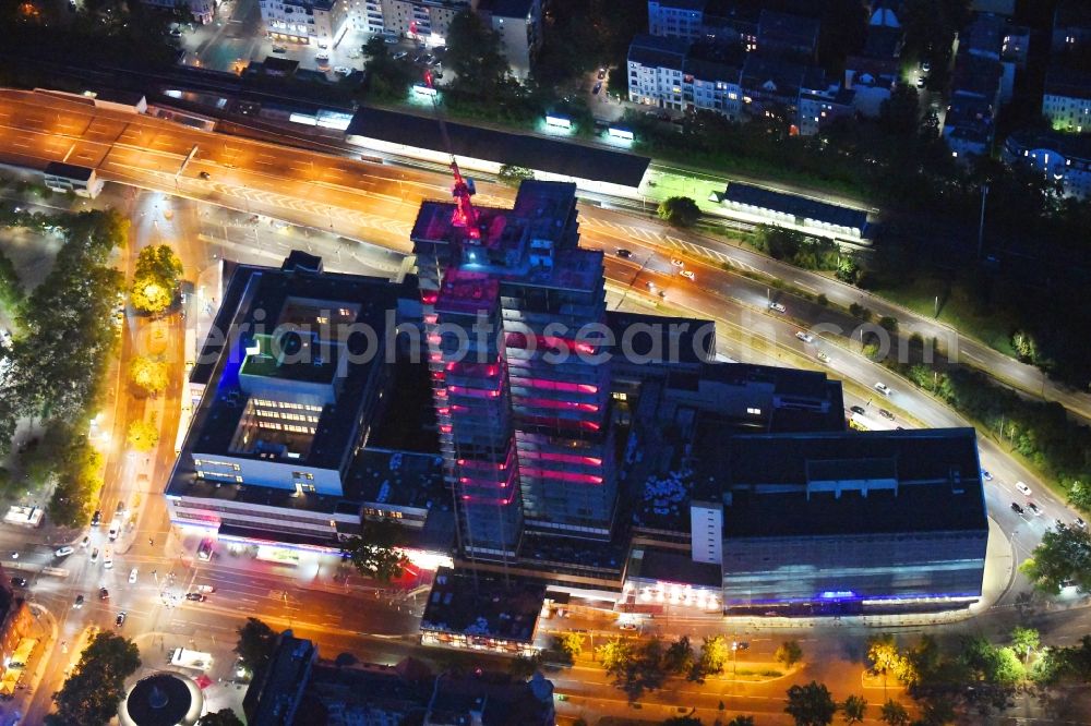 Berlin at night from the bird perspective: Night lighting highrise building of the Steglitzer Kreisel - UeBERLIN Wohntower complex on Schlossstrasse in the district of Steglitz in Berlin