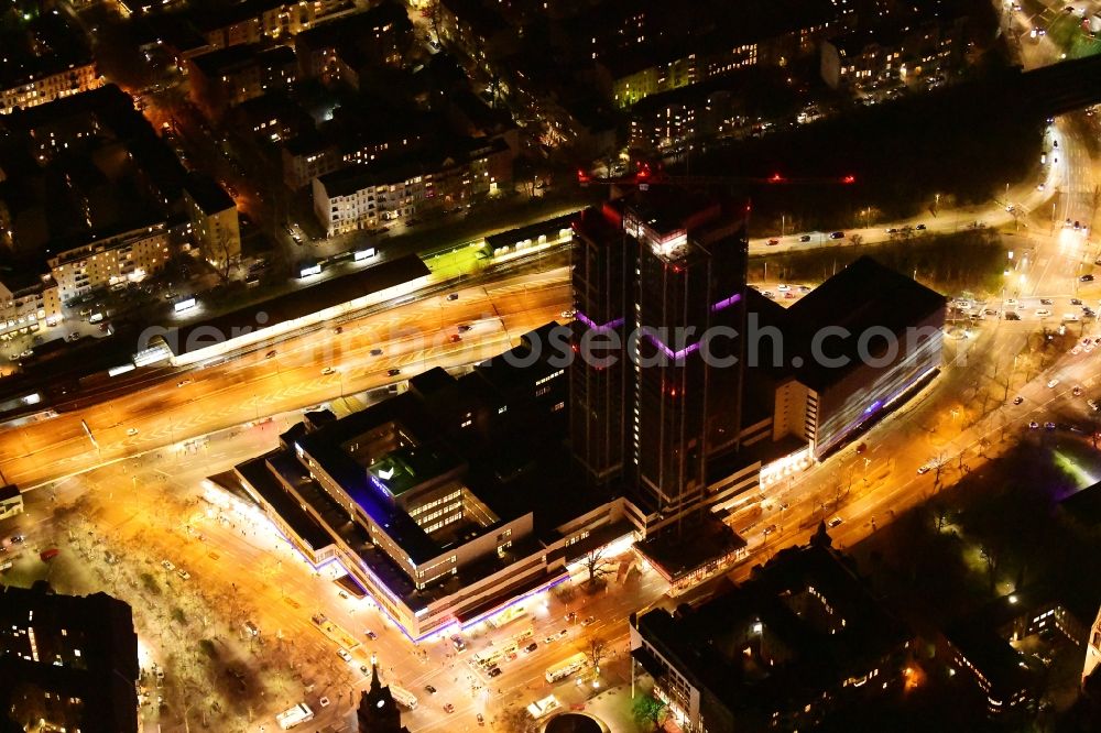 Aerial photograph at night Berlin - Night lighting highrise building of the Steglitzer Kreisel - UeBERLIN Wohntower complex on Schlossstrasse in the district of Steglitz in Berlin
