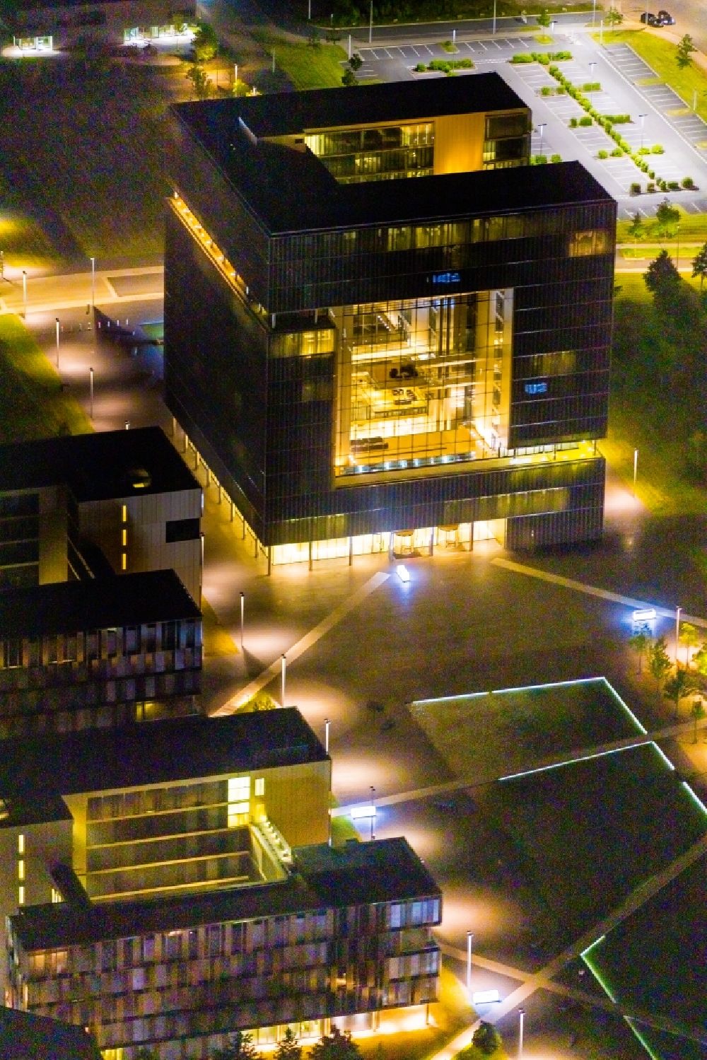 Essen at night from the bird perspective: Night lighting administration building of the company of Thyssenkrupp AG Building ensemble Krupp - Guertel in Krupp Park on Altendorfer Strasse at the corner of Berthold-Beitz-Boulevard in the district Westviertel in Essen at Ruhrgebiet in the state North Rhine-Westphalia, Germany