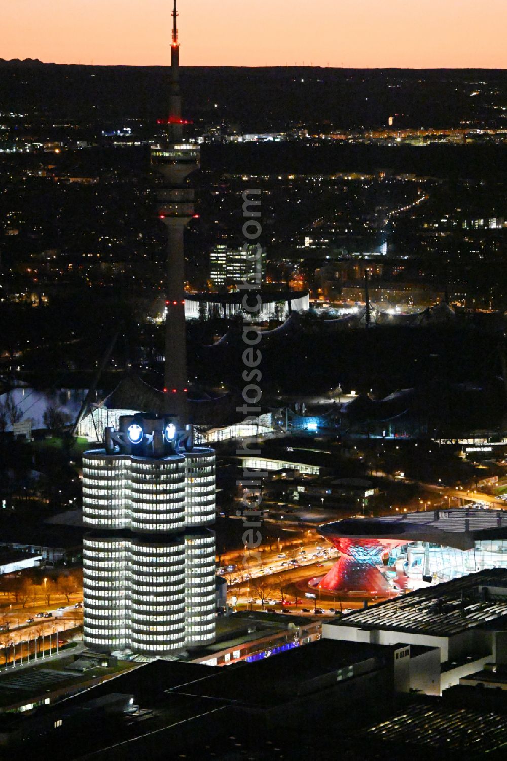 München at night from the bird perspective: Night lighting administration building of the company Vierzylinof of BMW AG in the district Milbertshofen-Am Hart in Munich in the state Bavaria, Germany