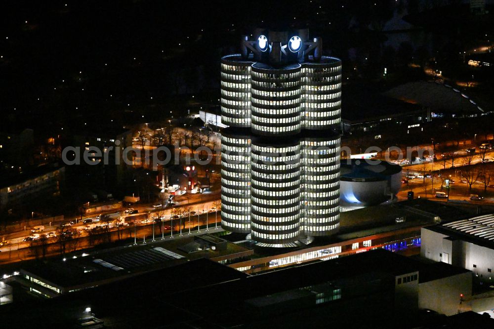 Aerial photograph at night München - Night lighting administration building of the company Vierzylinof of BMW AG in the district Milbertshofen-Am Hart in Munich in the state Bavaria, Germany