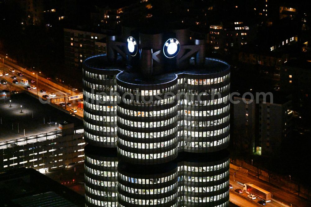 Aerial image at night München - Night lighting administration building of the company Vierzylinof of BMW AG in the district Milbertshofen-Am Hart in Munich in the state Bavaria, Germany