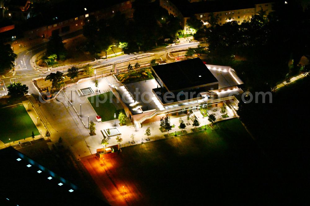 Aerial photograph at night Potsdam - Night lighting building of the indoor arena DAS MINSK Kunsthaus on street Max-Planck-Strasse in Potsdam in the state Brandenburg, Germany