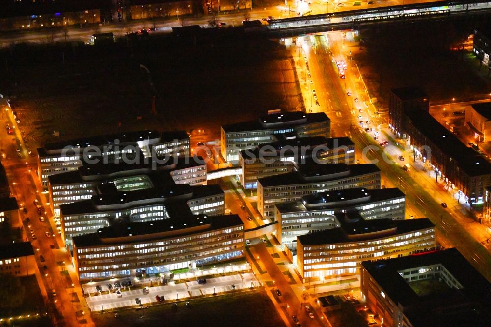 Aerial photograph at night Berlin - Night lighting office and administration buildings of the insurance company Allianz Campus Berlin in the district Adlershof in Berlin, Germany