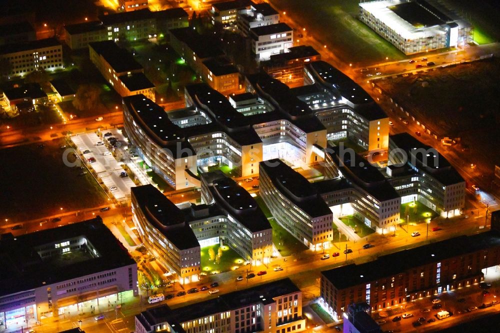 Aerial image at night Berlin - Night lighting office and administration buildings of the insurance company Allianz Campus Berlin in the district Adlershof in Berlin, Germany