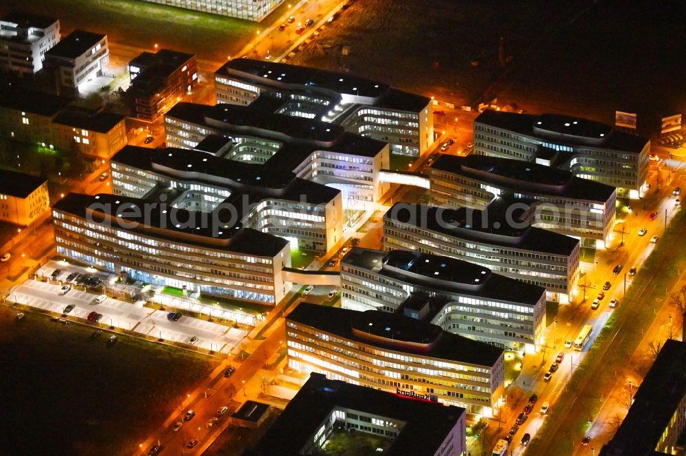 Aerial image at night Berlin - Night lighting office and administration buildings of the insurance company Allianz Campus Berlin in the district Adlershof in Berlin, Germany