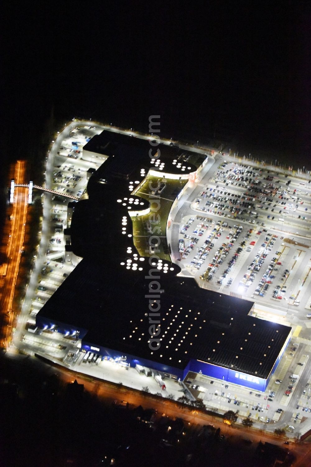 Aerial image at night Lübeck - Night view building the shopping mall LUV SHOPPING at IKEA furnishing house in Daenischburg, Luebeck in Schleswig-Holstein
