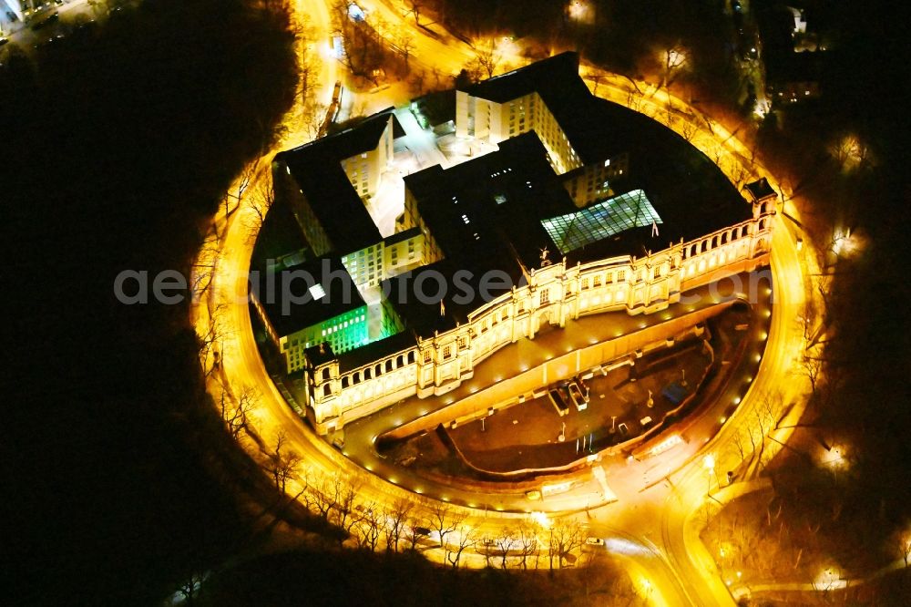 München at night from the bird perspective: Night view of palatial building Maximilianeum in the Haidhausen part of Munich in the state of Bavaria. The historic building is located on the Maximilian Bridge and includes the foundation Maximilianeum and has been seat of the Bavarian parliament
