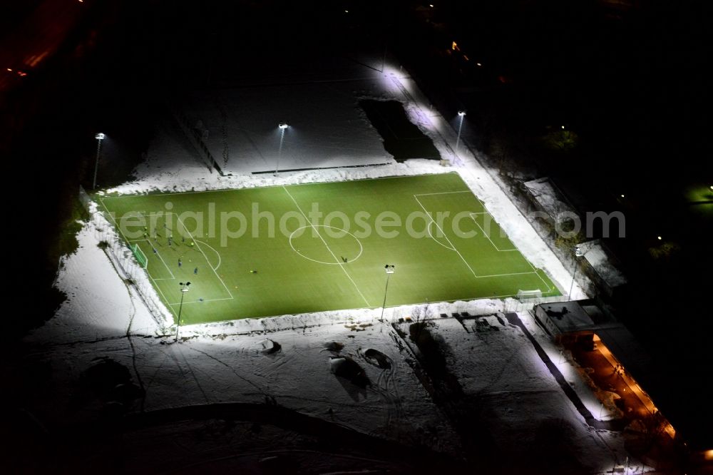 München at night from the bird perspective: Night aerial view of the with floodlight illuminated soccer field of the sports ground Perlach-Ost in Munich in Bavaria