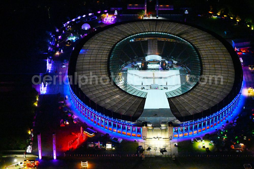 Aerial photograph at night Berlin - Night lights and lighting of construction work in preparation for the festival Lollapalooza sports venue area of the arena of the Olympic Stadium in Berlin