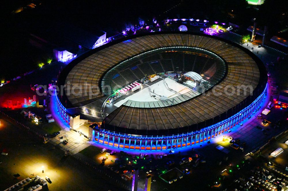 Berlin at night from the bird perspective: Night lights and lighting of construction work in preparation for the festival Lollapalooza sports venue area of the arena of the Olympic Stadium in Berlin