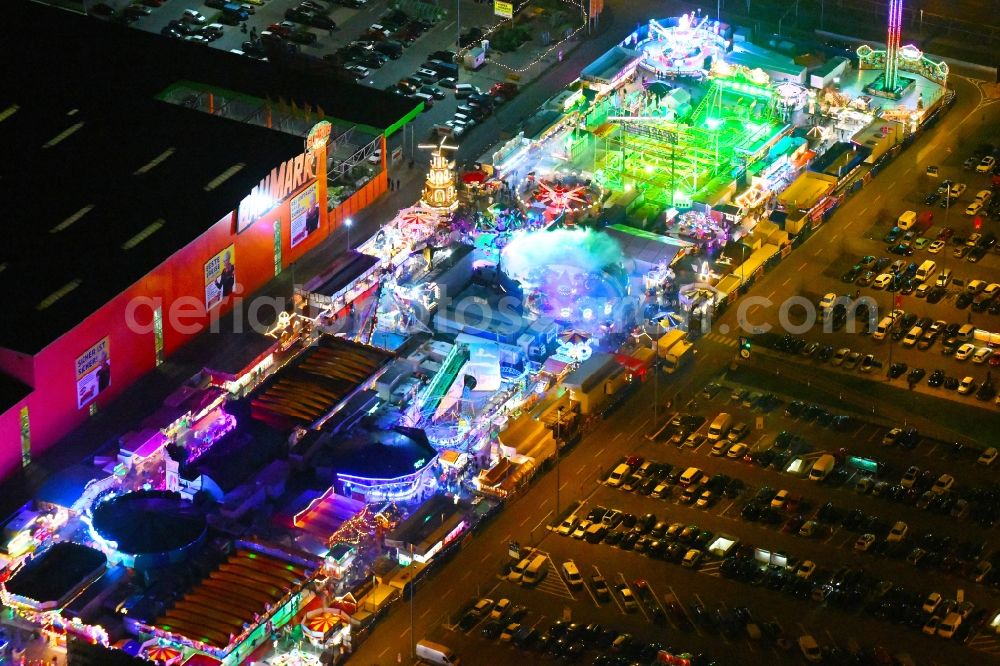 Berlin at night from above - Night lighting christmas - event site on Landsberger Allee in the district Lichtenberg in Berlin, Germany