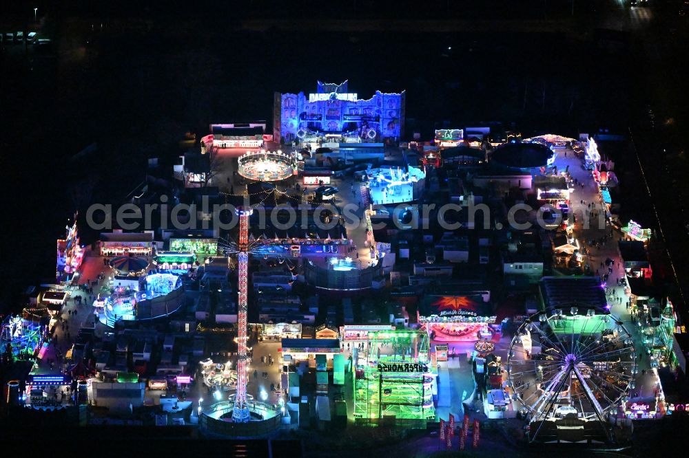 Berlin at night from the bird perspective: Night lighting christmas - event site on street Landsberger Allee in the district Lichtenberg in Berlin, Germany