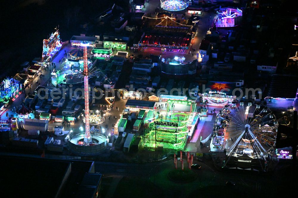 Aerial image at night Berlin - Night lighting christmas - event site on street Landsberger Allee in the district Lichtenberg in Berlin, Germany