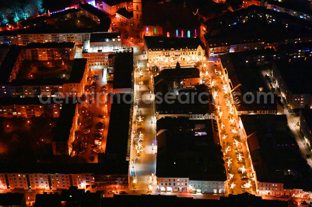 Aerial image at night Bernau - Night lighting christmassy market event grounds and sale huts and booths on street Marktplatz - Buergermeisterstrasse in Bernau in the state Brandenburg, Germany