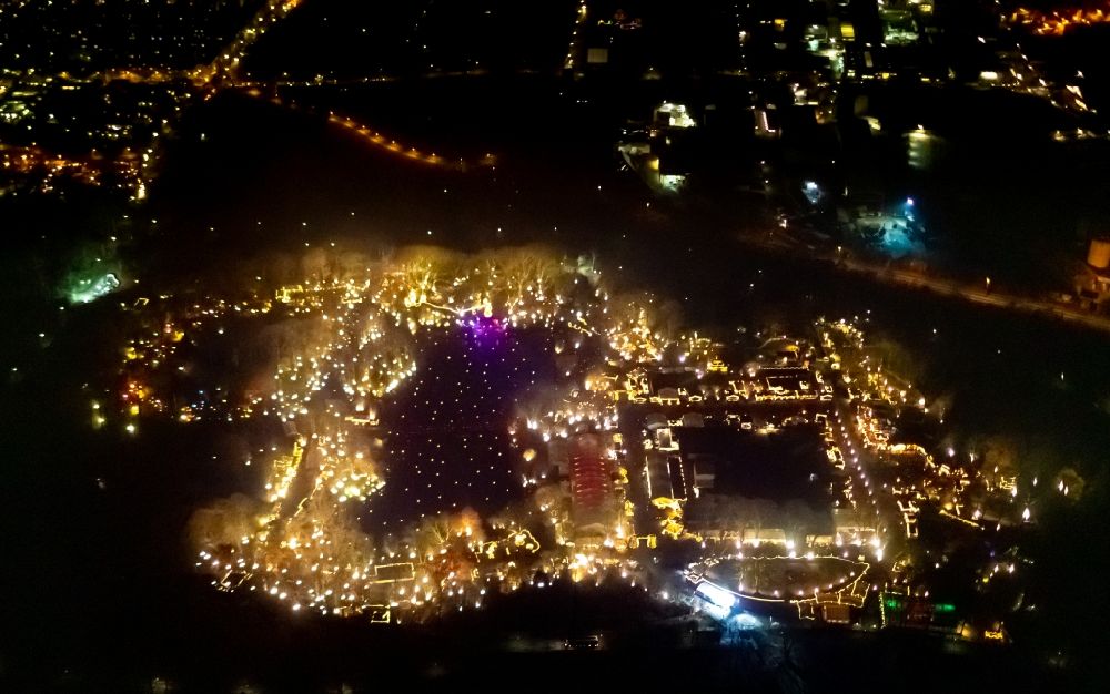 Aerial image at night Dortmund - Night lighting christmassy market event grounds and sale huts and booths in Fredenbaumpark in Dortmund in the state North Rhine-Westphalia, Germany