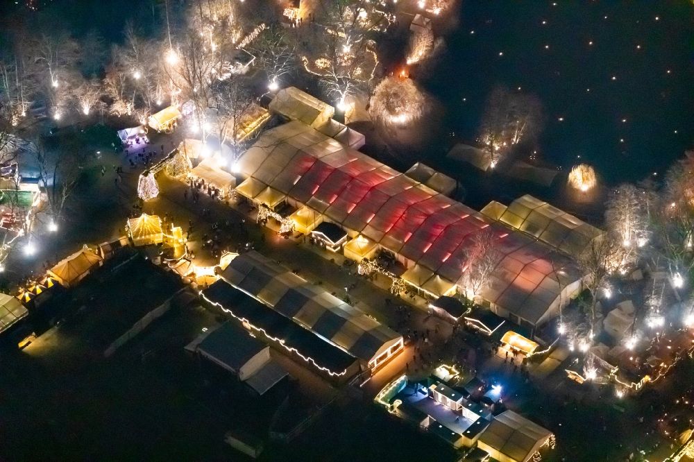 Dortmund at night from the bird perspective: Night lighting christmassy market event grounds and sale huts and booths in Fredenbaumpark in Dortmund in the state North Rhine-Westphalia, Germany