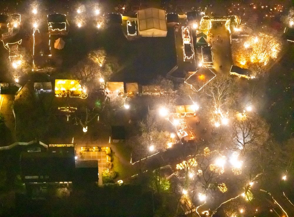 Dortmund at night from the bird perspective: Night lighting christmassy market event grounds and sale huts and booths in Fredenbaumpark in Dortmund in the state North Rhine-Westphalia, Germany