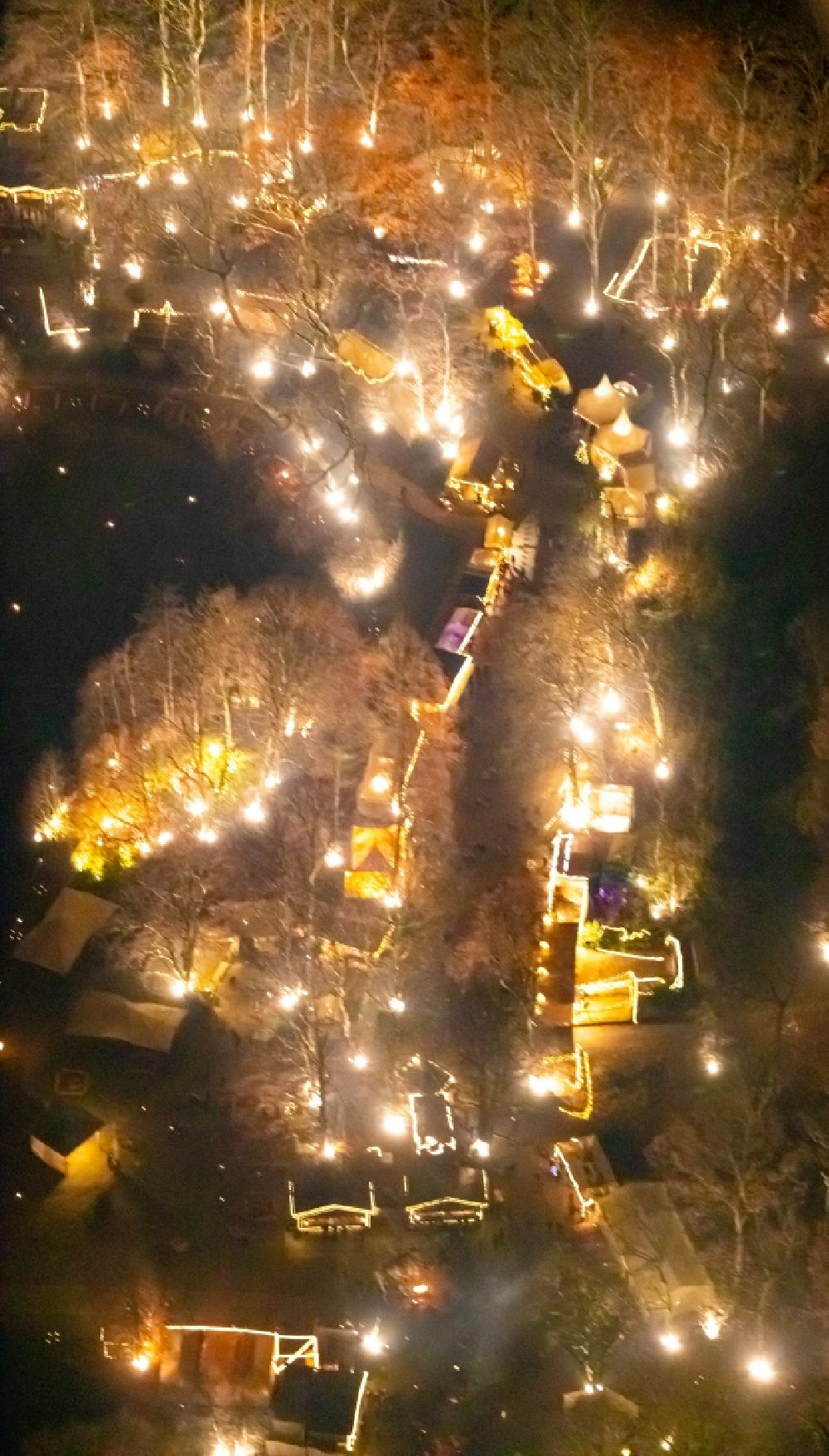 Aerial photograph at night Dortmund - Night lighting christmassy market event grounds and sale huts and booths in Fredenbaumpark in Dortmund in the state North Rhine-Westphalia, Germany