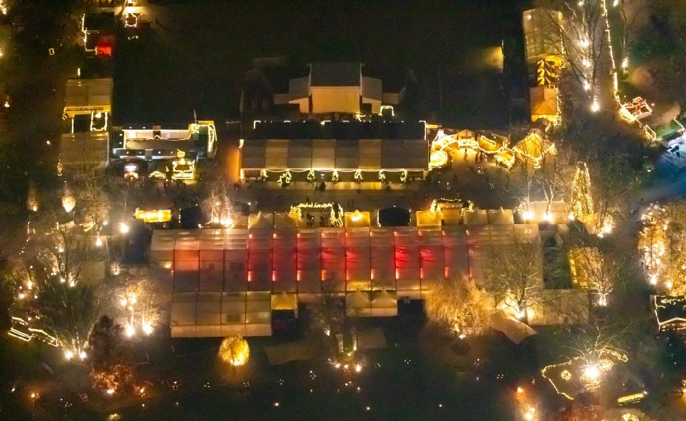Aerial image at night Dortmund - Night lighting christmassy market event grounds and sale huts and booths in Fredenbaumpark in Dortmund in the state North Rhine-Westphalia, Germany