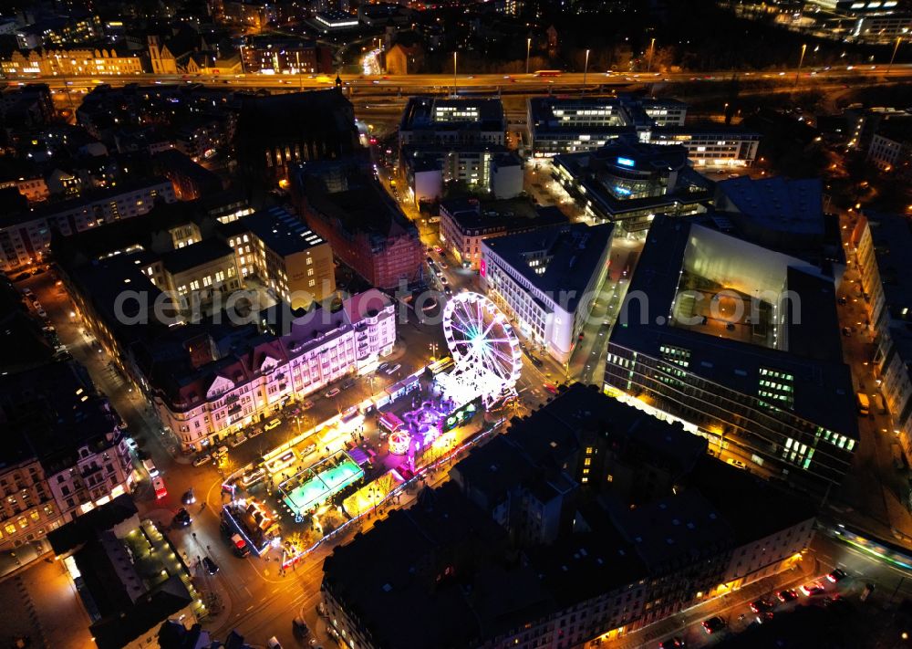 Aerial image at night Halle (Saale) - Night lighting christmassy market event grounds and sale huts and booths on place Marktplatz in the district Altstadt in Halle (Saale) in the state Saxony-Anhalt, Germany