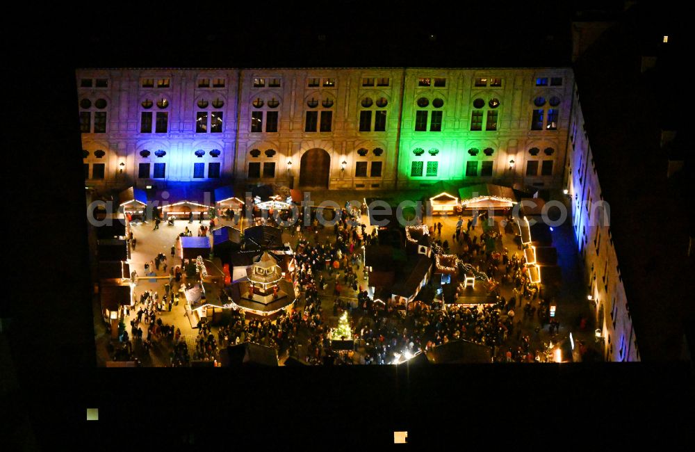 Aerial image at night München - Night lighting christmassy market event grounds and sale huts and booths in Innenhof of Residenz - Alte Hofkapelle on street Residenzstrasse in the district Altstadt in Munich in the state Bavaria, Germany