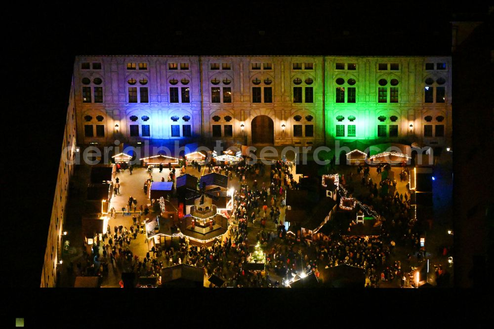 München at night from above - Night lighting christmassy market event grounds and sale huts and booths in Innenhof of Residenz - Alte Hofkapelle on street Residenzstrasse in the district Altstadt in Munich in the state Bavaria, Germany