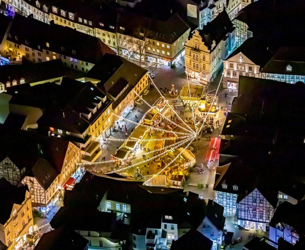Unna at night from the bird perspective: Night lighting christmassy market event grounds and sale huts and booths on the marketplace in Unna in the state North Rhine-Westphalia, Germany