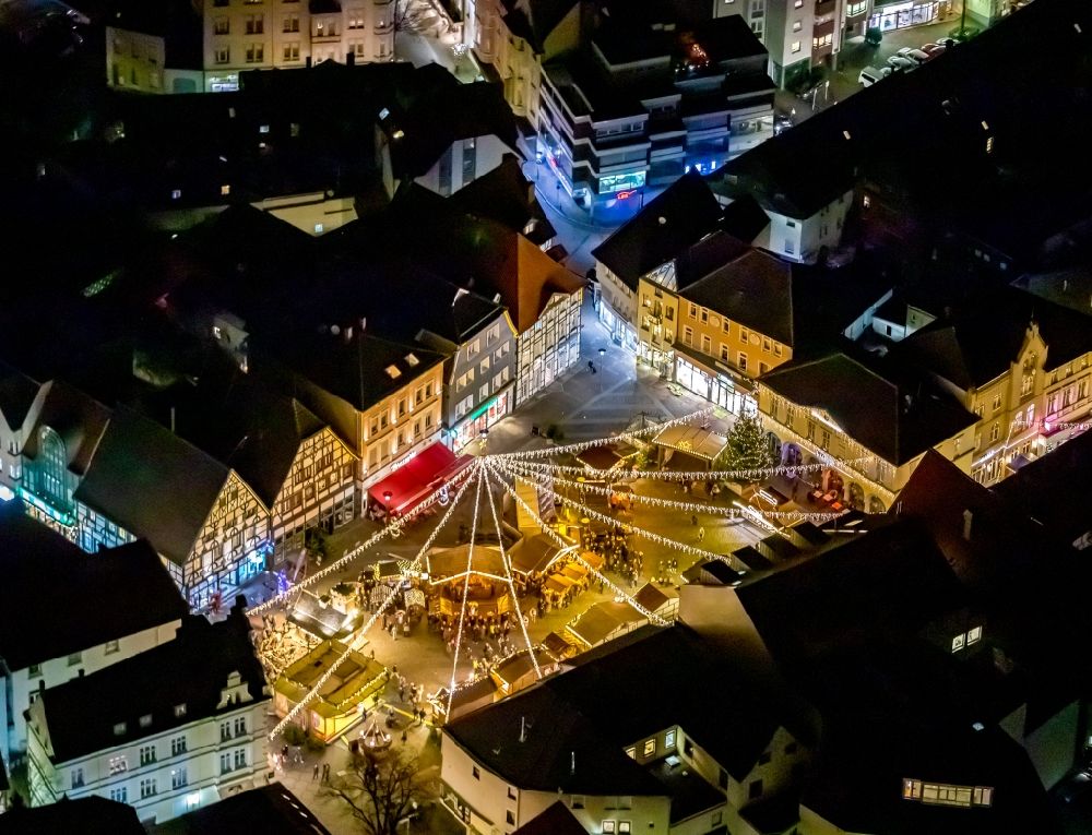 Aerial photograph at night Unna - Night lighting christmassy market event grounds and sale huts and booths on the marketplace in Unna in the state North Rhine-Westphalia, Germany