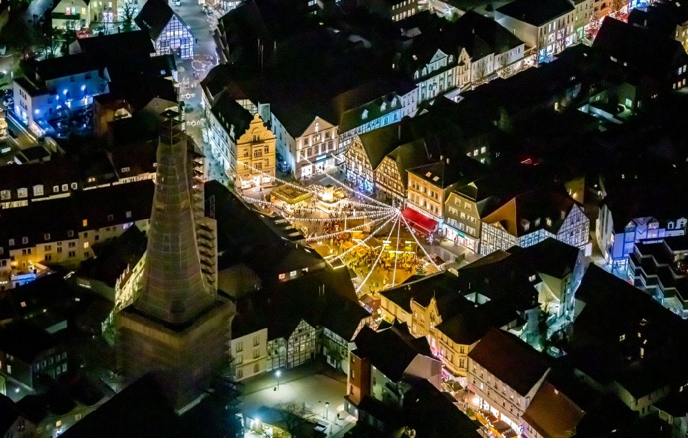 Aerial image at night Unna - Night lighting christmassy market event grounds and sale huts and booths on the marketplace in Unna in the state North Rhine-Westphalia, Germany