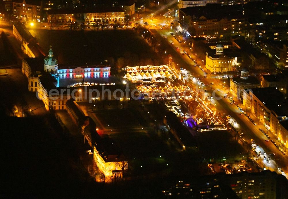 Berlin at night from above - Night lighting Christmassy market event grounds and sale huts and booths on Schloss Charlottenburg in the district Charlottenburg in Berlin, Germany