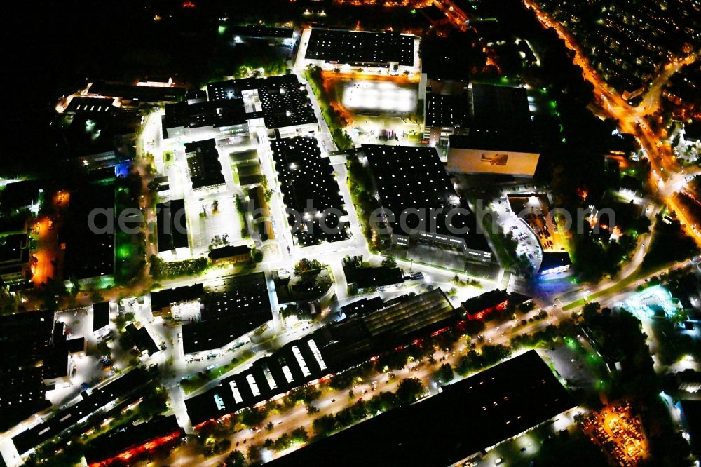Berlin at night from the bird perspective: Night lighting factory area of a??a??the Bayerische Motoren Werke / BMW AG motorcycle plant at the Juliusturm in the district of Spandau in Berlin, Germany
