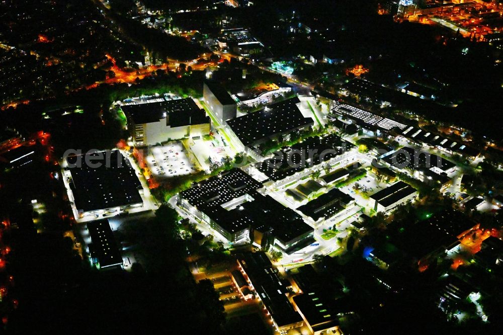 Berlin at night from the bird perspective: Night lighting factory area of the Bayerische Motoren Werke / BMW AG motorcycle plant at the Juliusturm in the district of Spandau in Berlin, Germany
