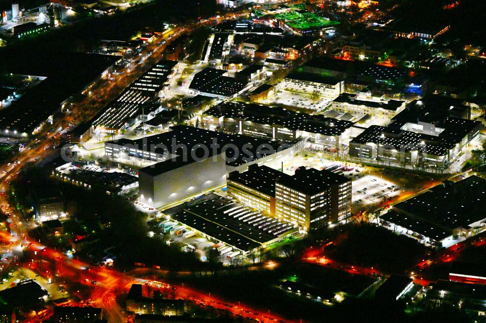 Aerial image at night Berlin - Night lighting factory area of the Bayerische Motoren Werke / BMW AG motorcycle plant at the Juliusturm in the district of Spandau in Berlin, Germany