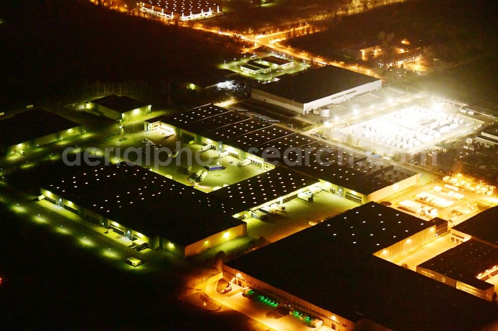 Ludwigsfelde at night from above - Night lighting building and production halls on the premises Am Birkengrund in Ludwigsfelde in the state Brandenburg, Germany