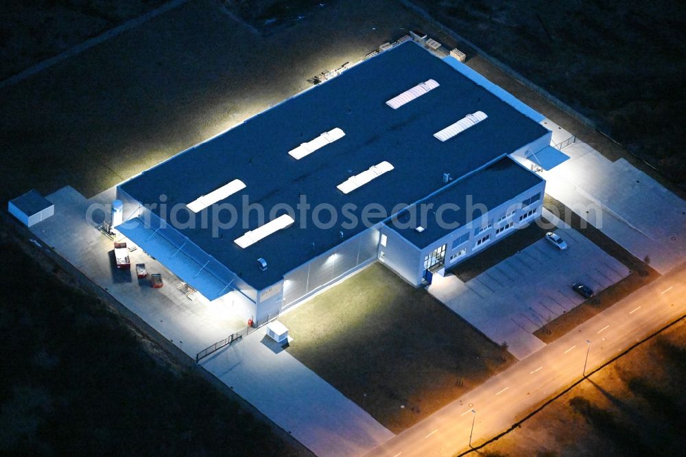 Aerial image at night Schwerin - Night lighting building and production halls on the premises of BVS Systemtechnik in Schwerin in the state Mecklenburg - Western Pomerania, Germany