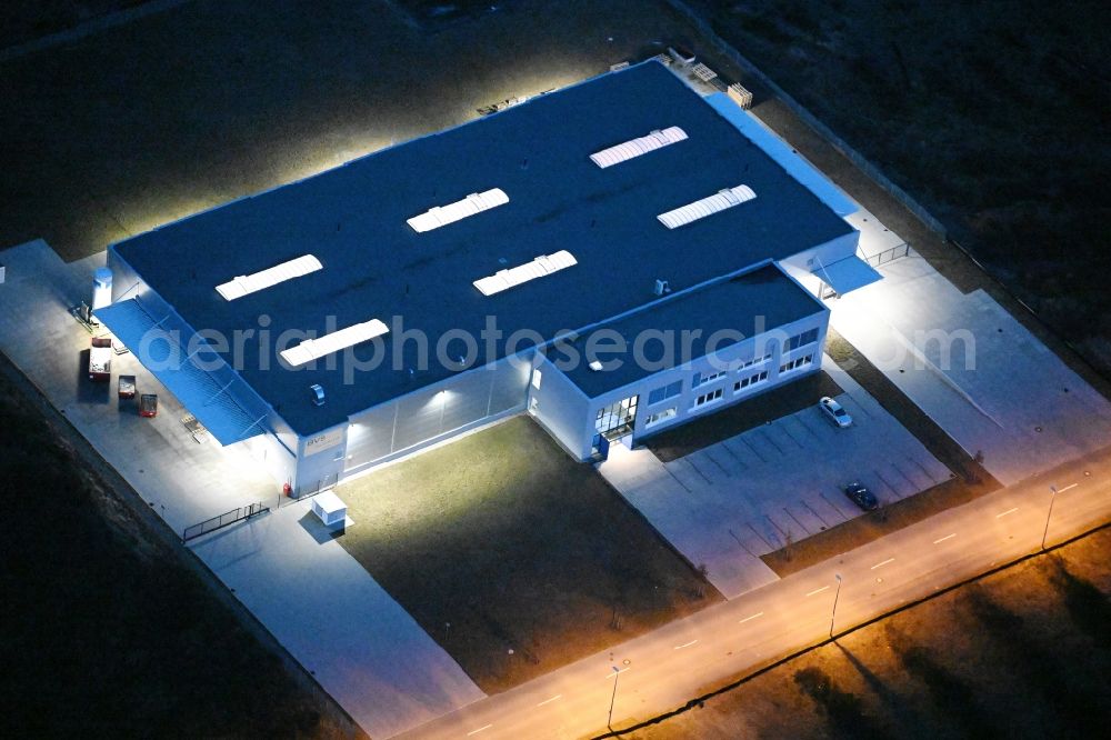 Schwerin at night from above - Night lighting building and production halls on the premises of BVS Systemtechnik in Schwerin in the state Mecklenburg - Western Pomerania, Germany