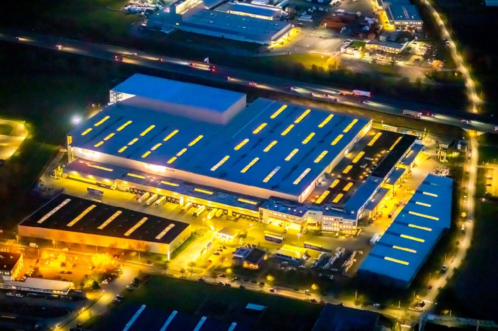 Aerial photograph at night Hamm - Night lighting building and production halls on the premises of Claas Service ond Parts GmbH on Kronstrasse in the district Uentrop in Hamm in the state North Rhine-Westphalia, Germany