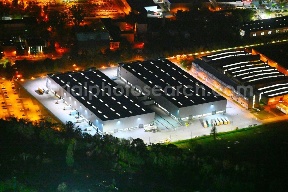 Aerial photograph at night Berlin - Night lighting building and production halls on the premises of Siemens Energy Schaltwerk Hochspannung (Switchgear Factory) on street Paulsternstrasse in the district Siemensstadt in Berlin, Germany