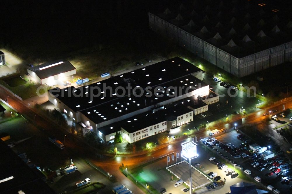 Ahrensfelde at night from above - Night lighting buildings and production halls on the factory premises of the offset printing Moeller Druck and Verlag GmbH on Zeppelinstrasse in the district Blumberg in Ahrensfelde in the state Brandenburg, Germany