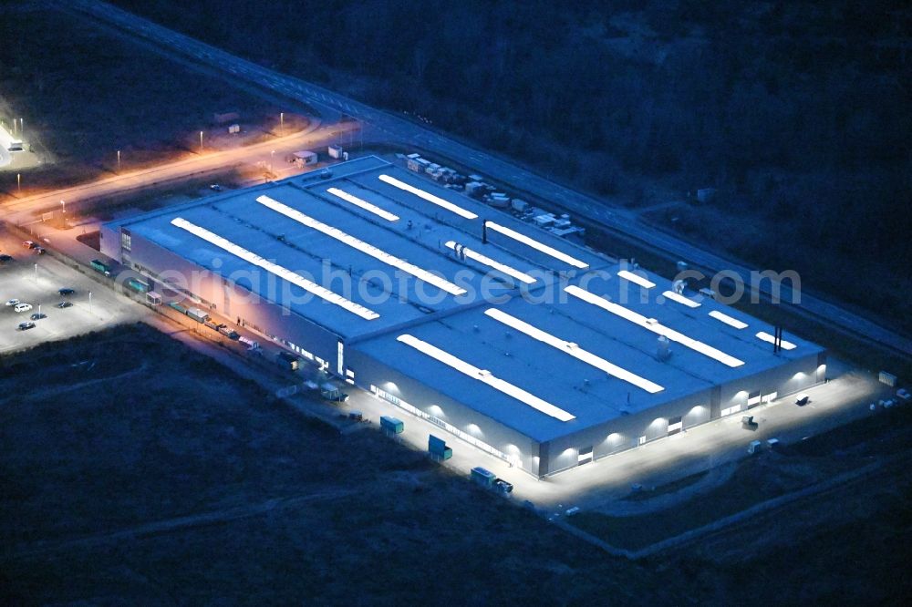 Schwerin at night from the bird perspective: Night lighting building and production halls on the premises of Flammaerotec GmbH & Co. KG on Ludwig-Boelkow-Strasse in Schwerin in the state Mecklenburg - Western Pomerania