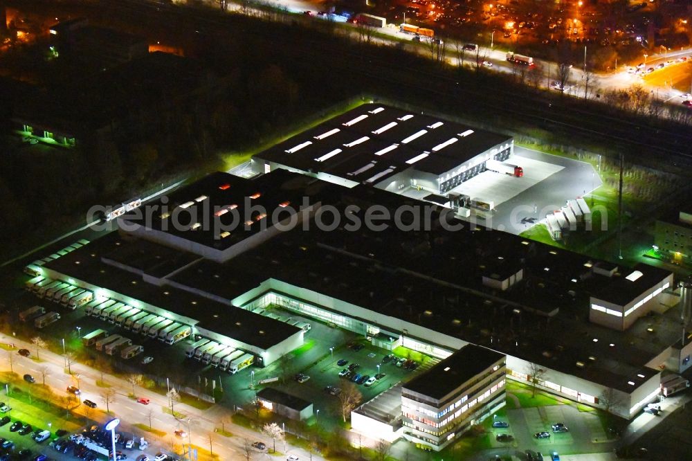Berlin at night from the bird perspective: Night lighting factory premises of Harry-Brot GmbH on Wolfener Strasse in the district Marzahn in Berlin, Germany