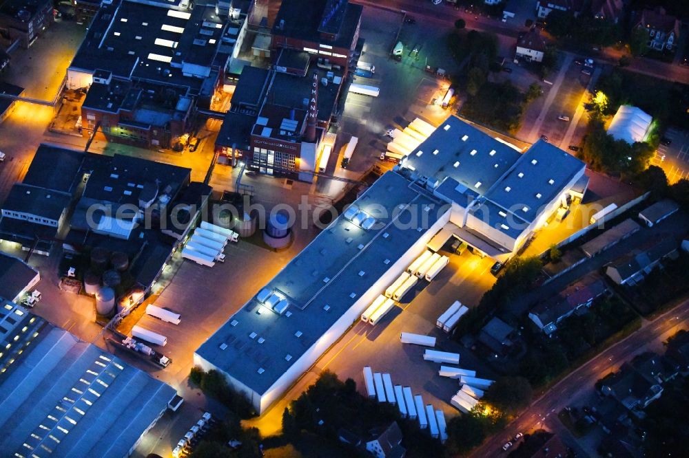 Dissen am Teutoburger Wald at night from the bird perspective: Night lighting Building and production halls on the premises of Homann Feinkost GmbH in Dissen am Teutoburger Wald in the state Lower Saxony, Germany