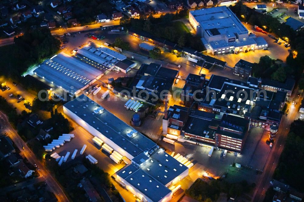 Dissen am Teutoburger Wald at night from above - Night lighting Building and production halls on the premises of Homann Feinkost GmbH in Dissen am Teutoburger Wald in the state Lower Saxony, Germany